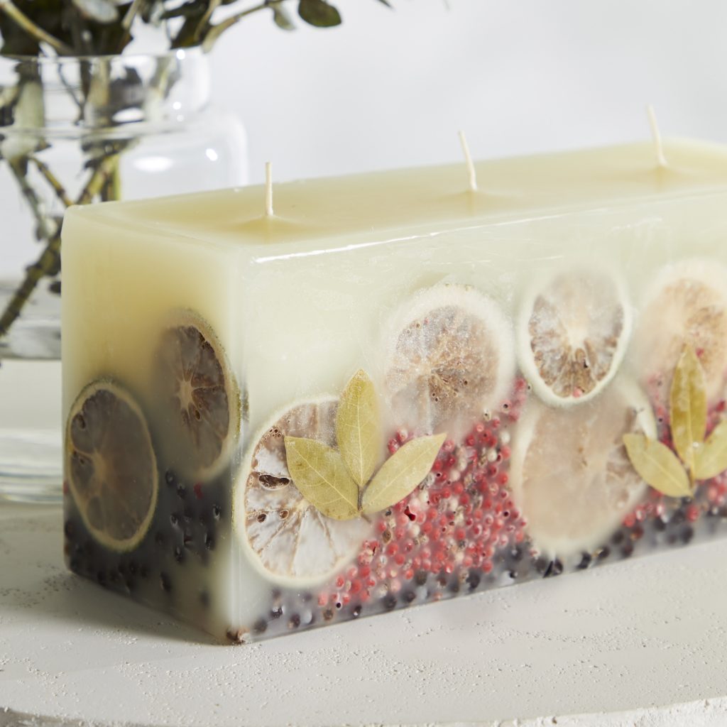 Brick shaped white candle with dried lemons limes fruit and three wicks