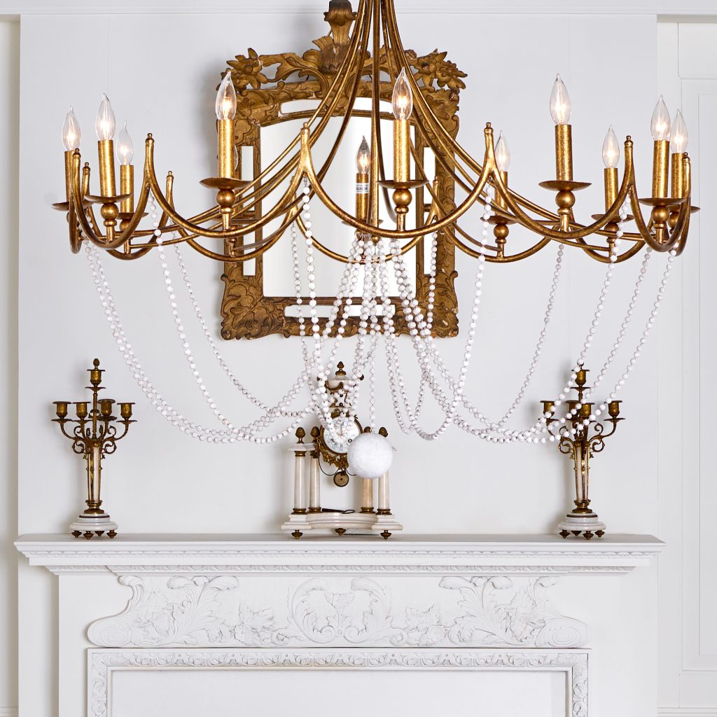 white carved French mantelpiece with brass and gilded candelabra and antique clock